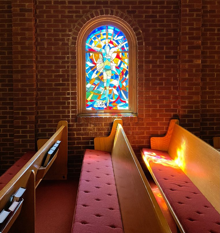 inside sanctuary of Union Church looking at stained glass window